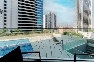 a swimming pool on the roof of a building at HAVN - New Studio Business Bay, Burj Khalifa View in Dubai