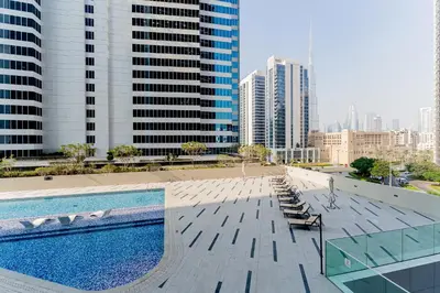 a swimming pool in a city with tall buildings at HAVN - New Studio Business Bay, Burj Khalifa View in Dubai