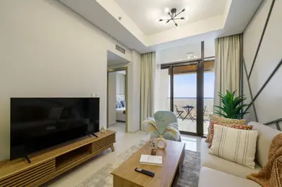 a living room with a large television and a couch at Higher Floor 2BR in Aykon City Discounted Prices in Dubai