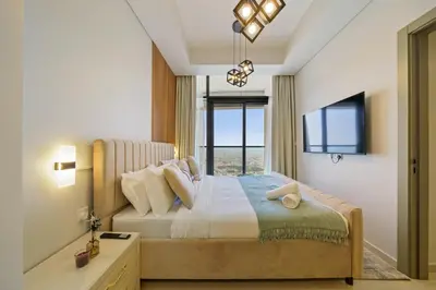 a bedroom with a large bed with a large window at Higher Floor 2BR in Aykon City Discounted Prices in Dubai