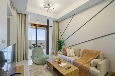 a living room with a couch and a table at Higher Floor 2BR in Aykon City Discounted Prices in Dubai