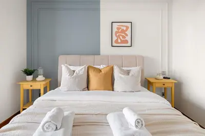 a bedroom with a large bed with towels on it at Silkhaus Cozy Studio at Sky Gardens-Heart of DIFC in Dubai