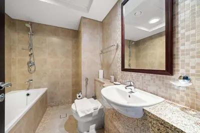 a bathroom with a sink and a toilet and a tub at Silkhaus Cozy Studio at Sky Gardens-Heart of DIFC in Dubai