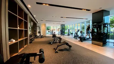 a gym with treadmills and exercise equipment in a building at Brand New 1BR Apt in Grande Residence, Downtown Dubai - Allsopp & Allsopp in Dubai