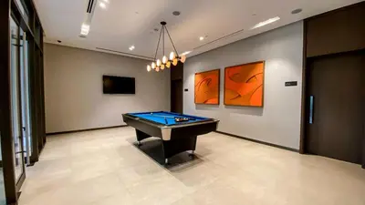 a billiard room with a pool table and paintings at Brand New 1BR Apt in Grande Residence, Downtown Dubai - Allsopp & Allsopp in Dubai