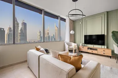 a living room with a couch and a large window at Silkhaus Sky Gardens at Homestyle Studio in DIFC in Dubai