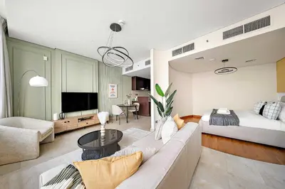 a living room with a couch and a bed at Silkhaus Sky Gardens at Homestyle Studio in DIFC in Dubai