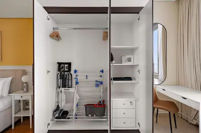 a small room with a bed and a closet at Silkhaus Sky Gardens at Homestyle Studio in DIFC in Dubai