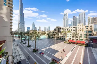 a tennis court in the middle of a city with buildings at Durrani Homes - Azure 2BR with Burj Khalifa and Fountain View in Dubai