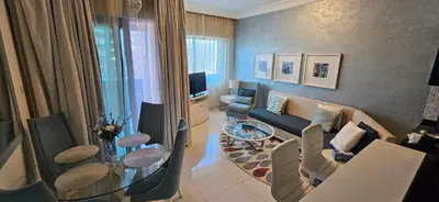 a living room with a couch and a table at Superb 1 BR apt next to Burj Khalifa and Dubai mall in Dubai