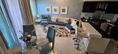 a living room with a couch and a table at Superb 1 BR apt next to Burj Khalifa and Dubai mall in Dubai