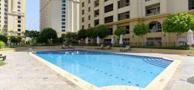 a large swimming pool in front of a building at WonderfulStay At JBR - Luxury Dubai Eye View Living - Beach Access - Brand New Luxury Apartments in Dubai