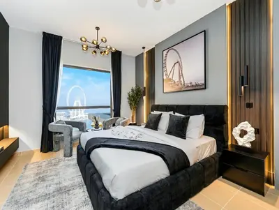 a bedroom with a large bed with a view of the wheel at WonderfulStay At JBR - Luxury Dubai Eye View Living - Beach Access - Brand New Luxury Apartments in Dubai