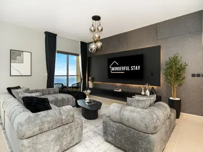 a living room with two couches and a tv at WonderfulStay At JBR - Luxury Dubai Eye View Living - Beach Access - Brand New Luxury Apartments in Dubai
