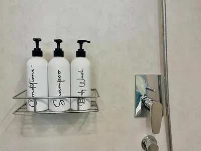 a group of three bottles of soap on a shelf at Boutique Studio in Palm Jumeirah - Stunning View in Dubai
