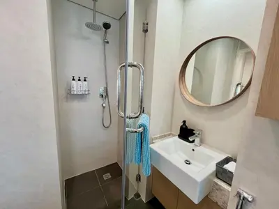 a bathroom with a shower and a sink and a mirror at Boutique Studio in Palm Jumeirah - Stunning View in Dubai