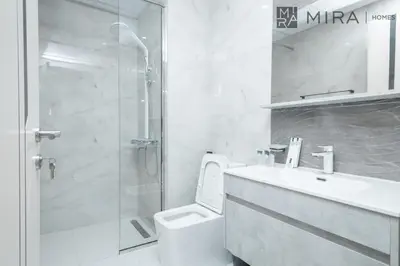 a bathroom with a shower and a toilet and a sink at Mira Holiday Homes - Cosy 1 bedroom close to metro Al Furjan in Dubai