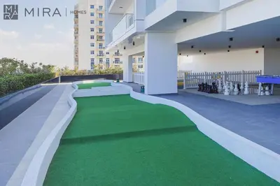 a green carpet on the side of a building at Mira Holiday Homes - Cosy 1 bedroom close to metro Al Furjan in Dubai