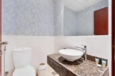 a bathroom with a sink and a toilet at Savis Home Oceanfront Serenity and Marina Views in Dubai