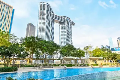 a swimming pool in front of a tall building at Burj Vista 2BR Luxurious Apartment with Direct Access to Dubai Mall in Dubai