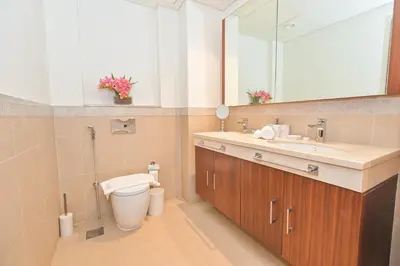 a bathroom with a toilet and a sink and a mirror at Burj Vista 2BR Luxurious Apartment with Direct Access to Dubai Mall in Dubai