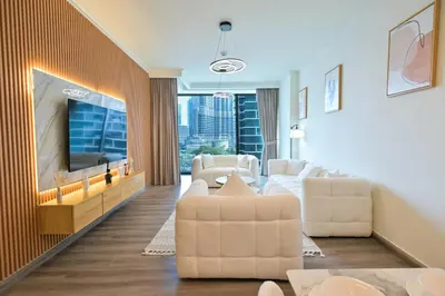 a living room with white furniture and a flat screen tv at Burj Vista 2BR Luxurious Apartment with Direct Access to Dubai Mall in Dubai