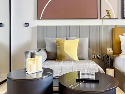 a living room with a bed and a table at Select Stay-Cozy Studio in MAG 318 with Canal View in Dubai
