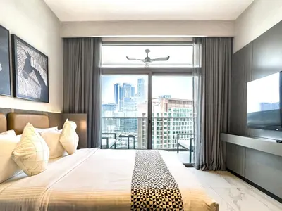 a bedroom with a bed and a large window at Select Stay-Cozy Studio in MAG 318 with Canal View in Dubai