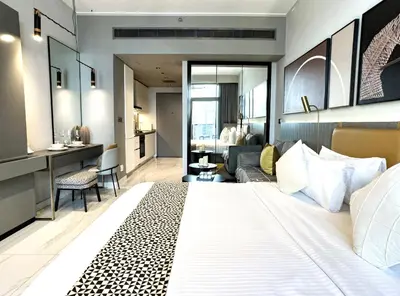 a bedroom with a large bed and a living room at Select Stay-Cozy Studio in MAG 318 with Canal View in Dubai
