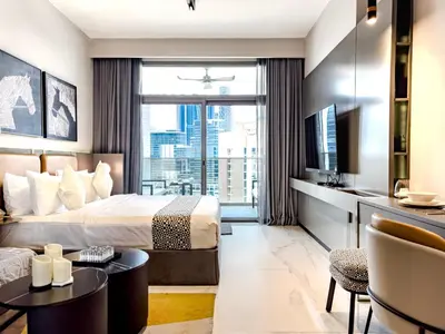 a hotel room with a bed and a tv at Select Stay-Cozy Studio in MAG 318 with Canal View in Dubai