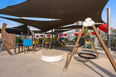 a playground with tables and chairs under a large umbrella at Select Stay-Cozy Studio in MAG 318 with Canal View in Dubai