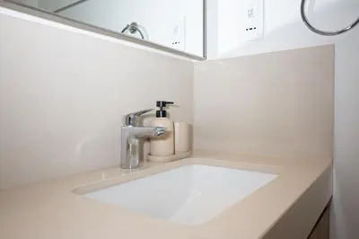 a bathroom sink with a faucet and a mirror at Apartment in Downtown Dubai in Dubai