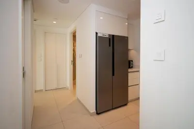 a kitchen with a stainless steel refrigerator in a room at Apartment in Downtown Dubai in Dubai