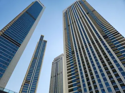 two tall buildings in a city against a blue sky at Apartment in Downtown Dubai in Dubai