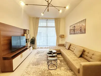 a living room with a couch and a flat screen tv at Meydan Marvel Sleek 1-Bedroom Home in Prime Views with Luxe Finishes! by Petals Holiday Homes in Dubai