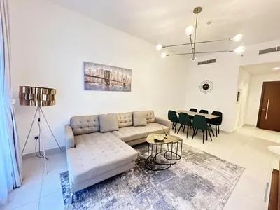 a living room with a couch and a table at Meydan Marvel Sleek 1-Bedroom Home in Prime Views with Luxe Finishes! by Petals Holiday Homes in Dubai