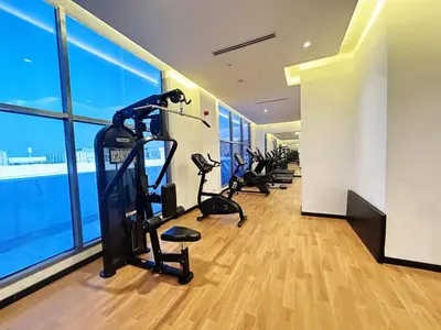 a gym with treadmills and ellipticals in a building at Meydan Marvel Sleek 1-Bedroom Home in Prime Views with Luxe Finishes! by Petals Holiday Homes in Dubai