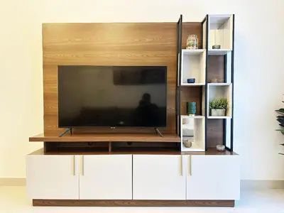 a entertainment center with a flat screen tv on top at Meydan Marvel Sleek 1-Bedroom Home in Prime Views with Luxe Finishes! by Petals Holiday Homes in Dubai