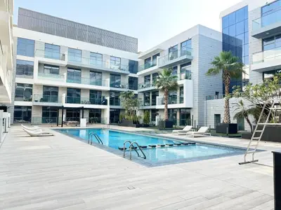 a swimming pool in front of a building at Meydan Marvel Sleek 1-Bedroom Home in Prime Views with Luxe Finishes! by Petals Holiday Homes in Dubai