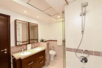 a bathroom with a shower and a sink and a toilet at The Boulevard Suite Luxury Burj Khalifa View - Downtown in Dubai
