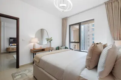 a bedroom with a large bed and a large window at The Boulevard Suite Luxury Burj Khalifa View - Downtown in Dubai