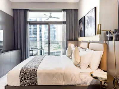 a bedroom with a large bed and a large window at Select Stay-Studio in MAG 318 - Minutes to Dubai Mall in Dubai