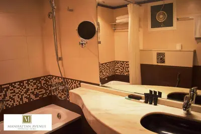 a bathroom with a sink and a mirror at Manhattan Avenue Hotel in Dubai