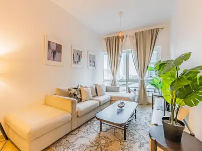 a living room with a couch and a table at Luxury Modern 1BR-Concorde Tower 1-JLT in Dubai
