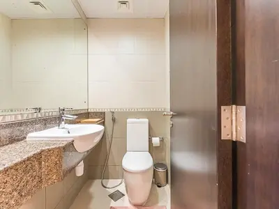 a bathroom with a toilet and a sink at Luxury Modern 1BR-Concorde Tower 1-JLT in Dubai