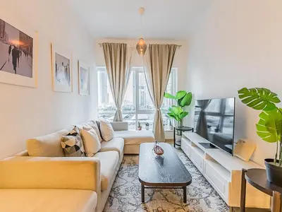 a living room with two couches and a tv at Luxury Modern 1BR-Concorde Tower 1-JLT in Dubai