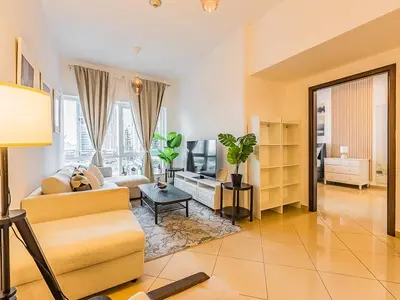 a living room with a couch and a table at Luxury Modern 1BR-Concorde Tower 1-JLT in Dubai