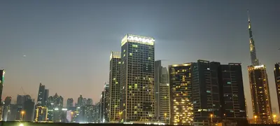 a large city skyline with tall buildings at night at Sky villa 103 in Dubai