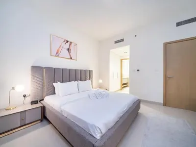 a large white bedroom with a large bed in it at Tranquil 1 Bedroom Dubai Hills Escape in Dubai