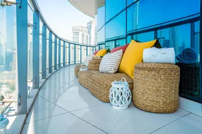 a balcony with couches and pillows on a building at 2 Bedrooms with Iconic Burj Khalifa Views Stay in Dubai